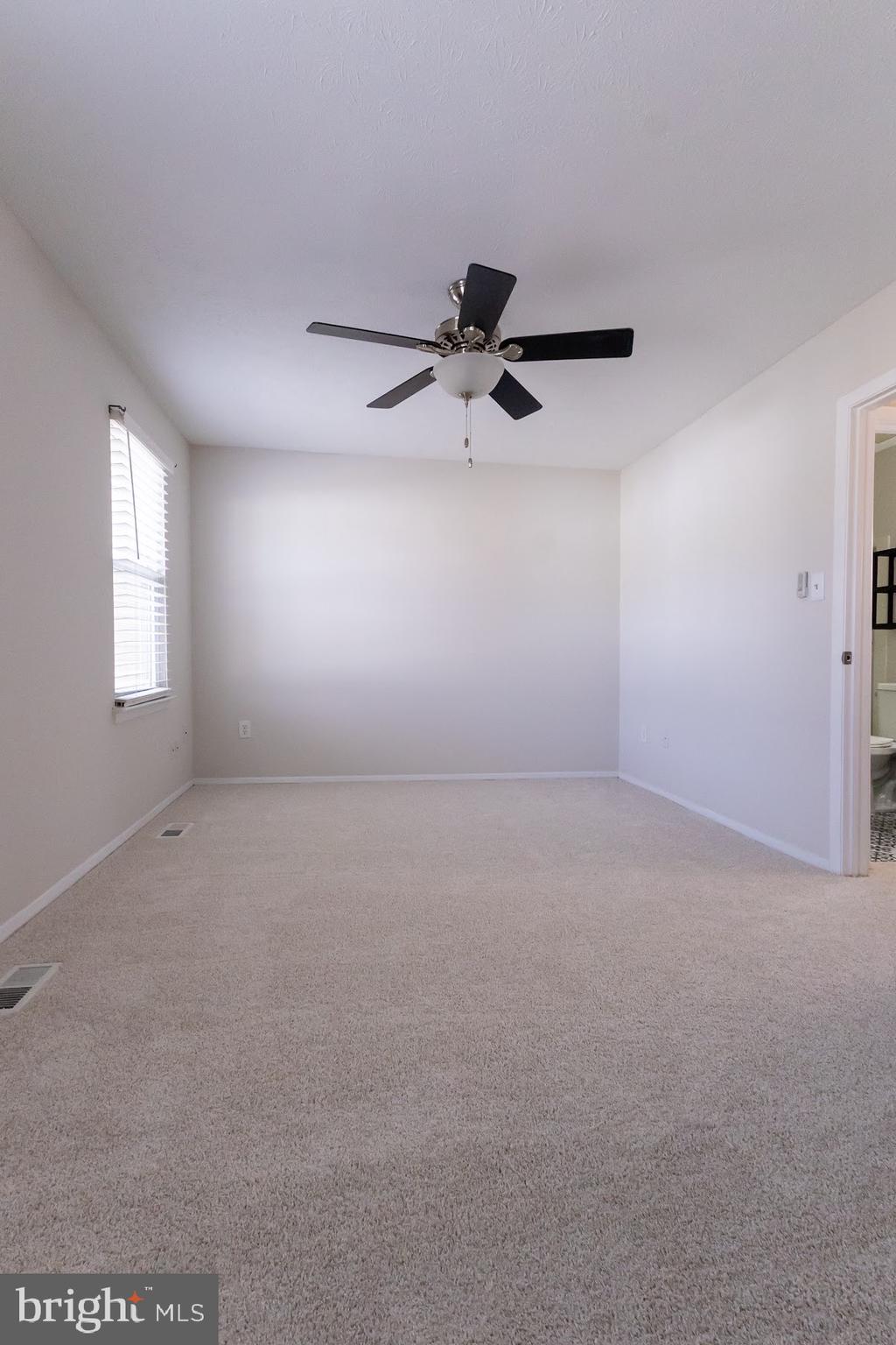 511 Kosoak Road Baltimore, MD 21220 - Photo 39 of 63 an empty room with a ceiling fan and window