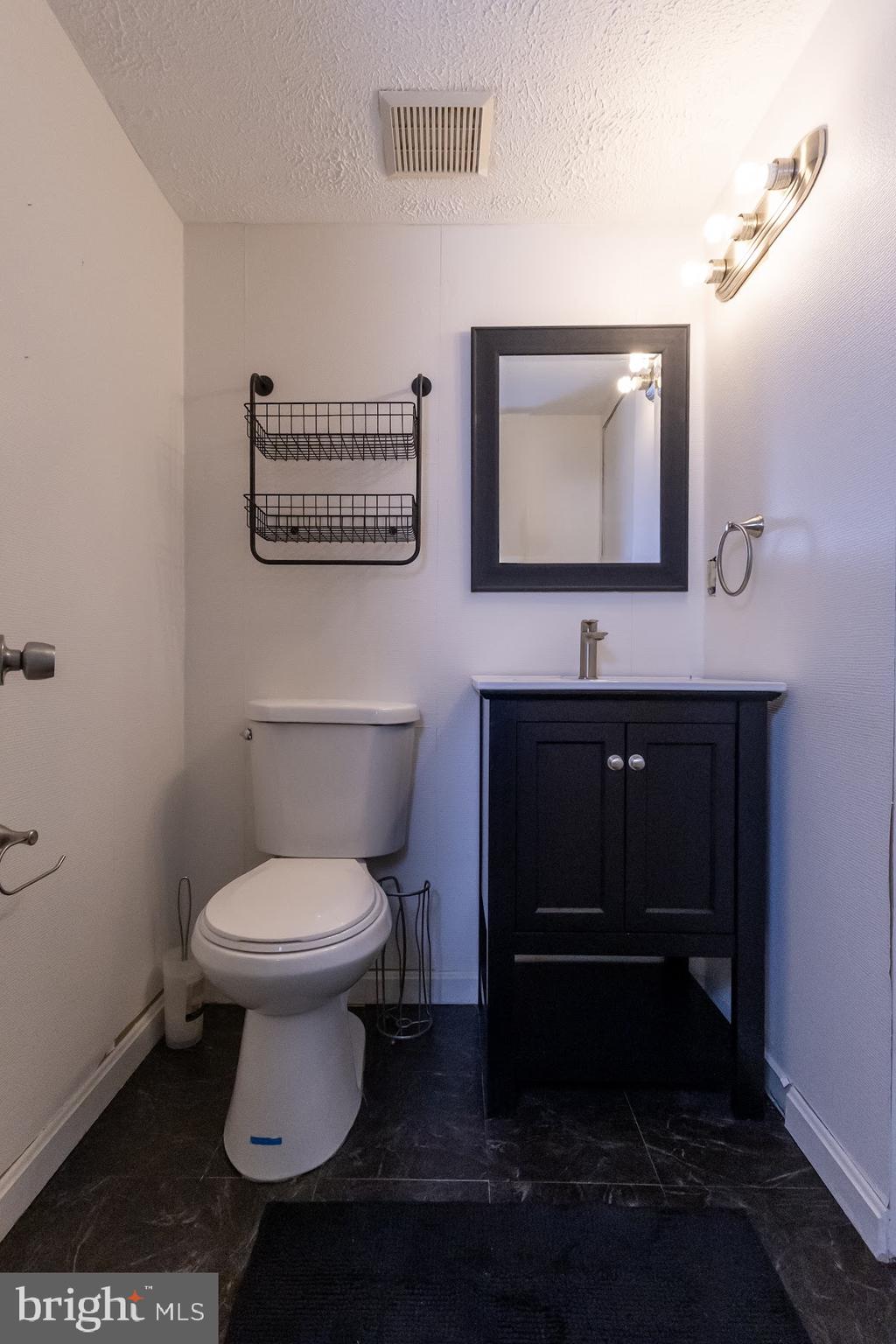 511 Kosoak Road Baltimore, MD 21220 - Photo 43 of 63 a bathroom with a toilet sink and mirror