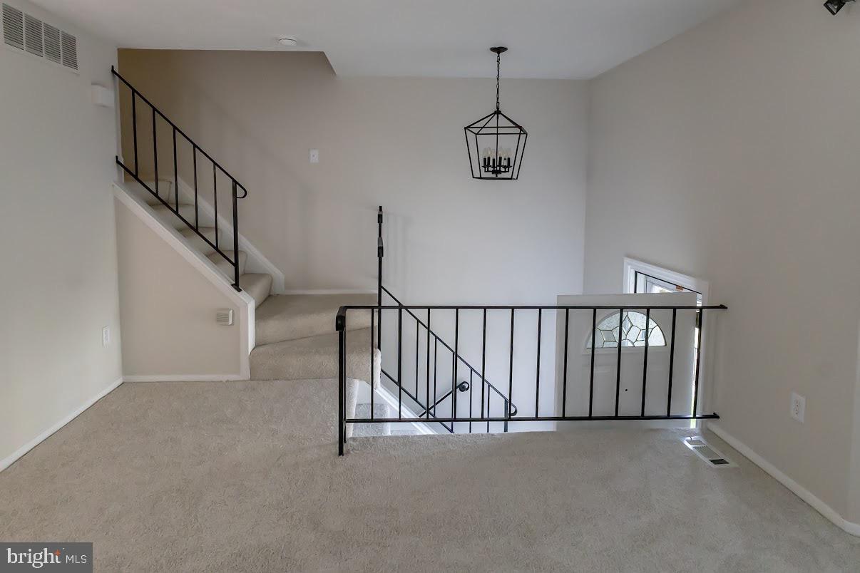 511 Kosoak Road Baltimore, MD 21220 - Photo 6 of 63 a view of staircase and hall with wooden floor