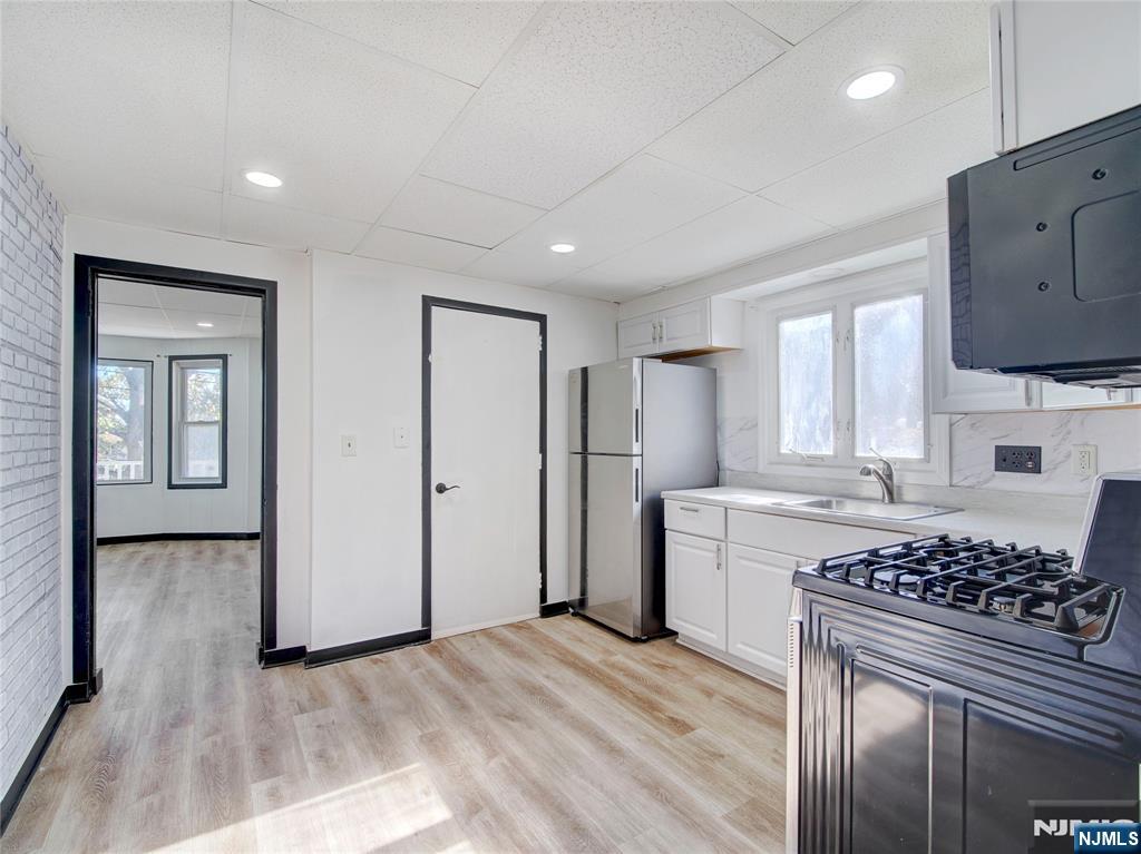 1761 Teaneck Road Teaneck, NJ 07666 - Photo 6 of 14 a kitchen with a stove a sink and a refrigerator