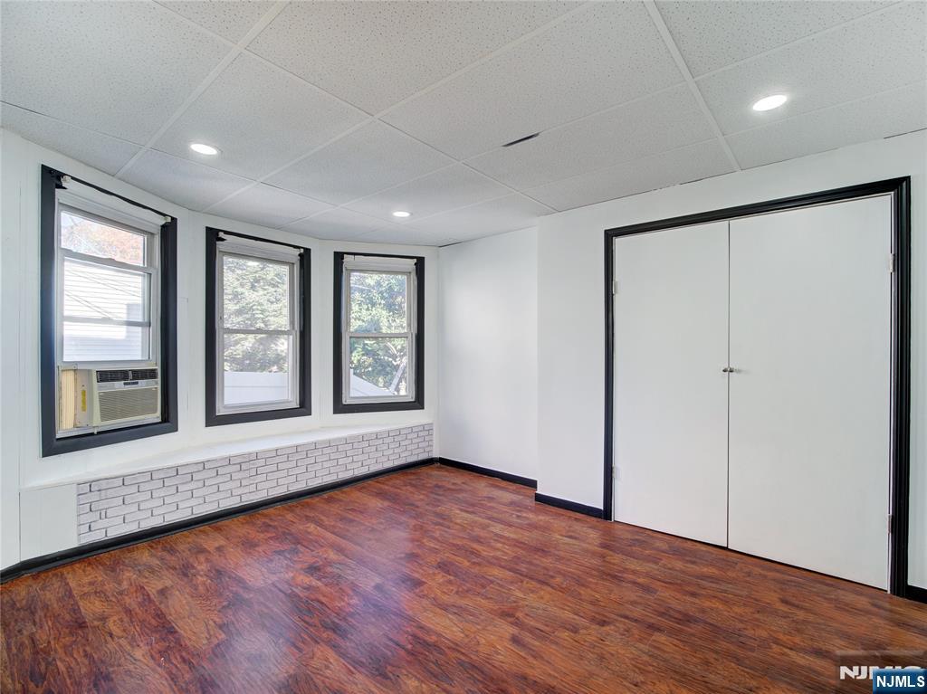 1761 Teaneck Road Teaneck, NJ 07666 - Photo 8 of 14 a view of an empty room with wooden floor and a window