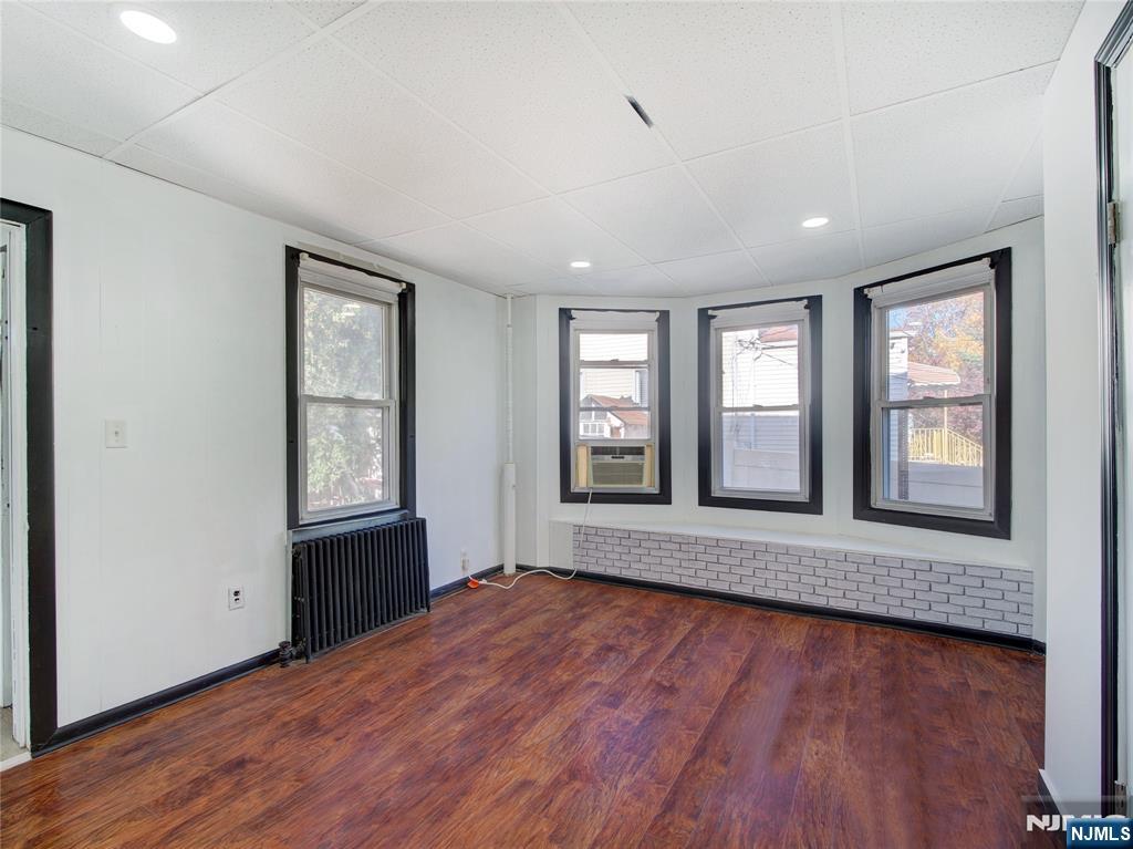 1761 Teaneck Road Teaneck, NJ 07666 - Photo 9 of 14 an empty room with wooden floor and windows