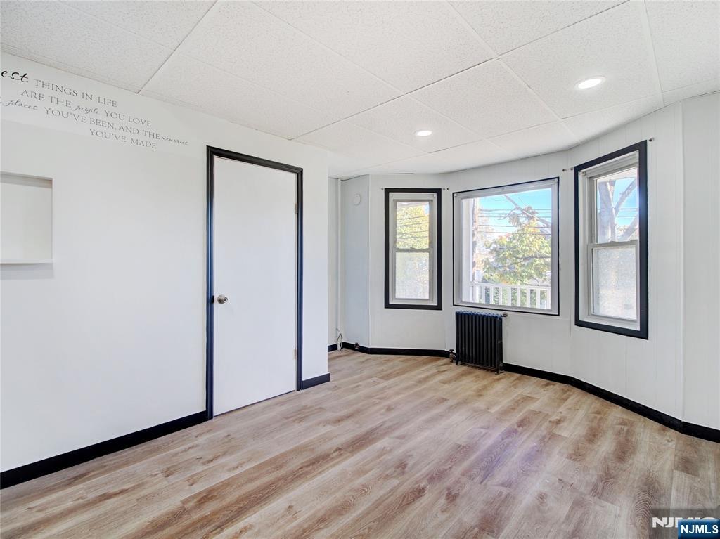 1761 Teaneck Road Teaneck, NJ 07666 - Photo 10 of 14 a view of an empty room with wooden floor and a window