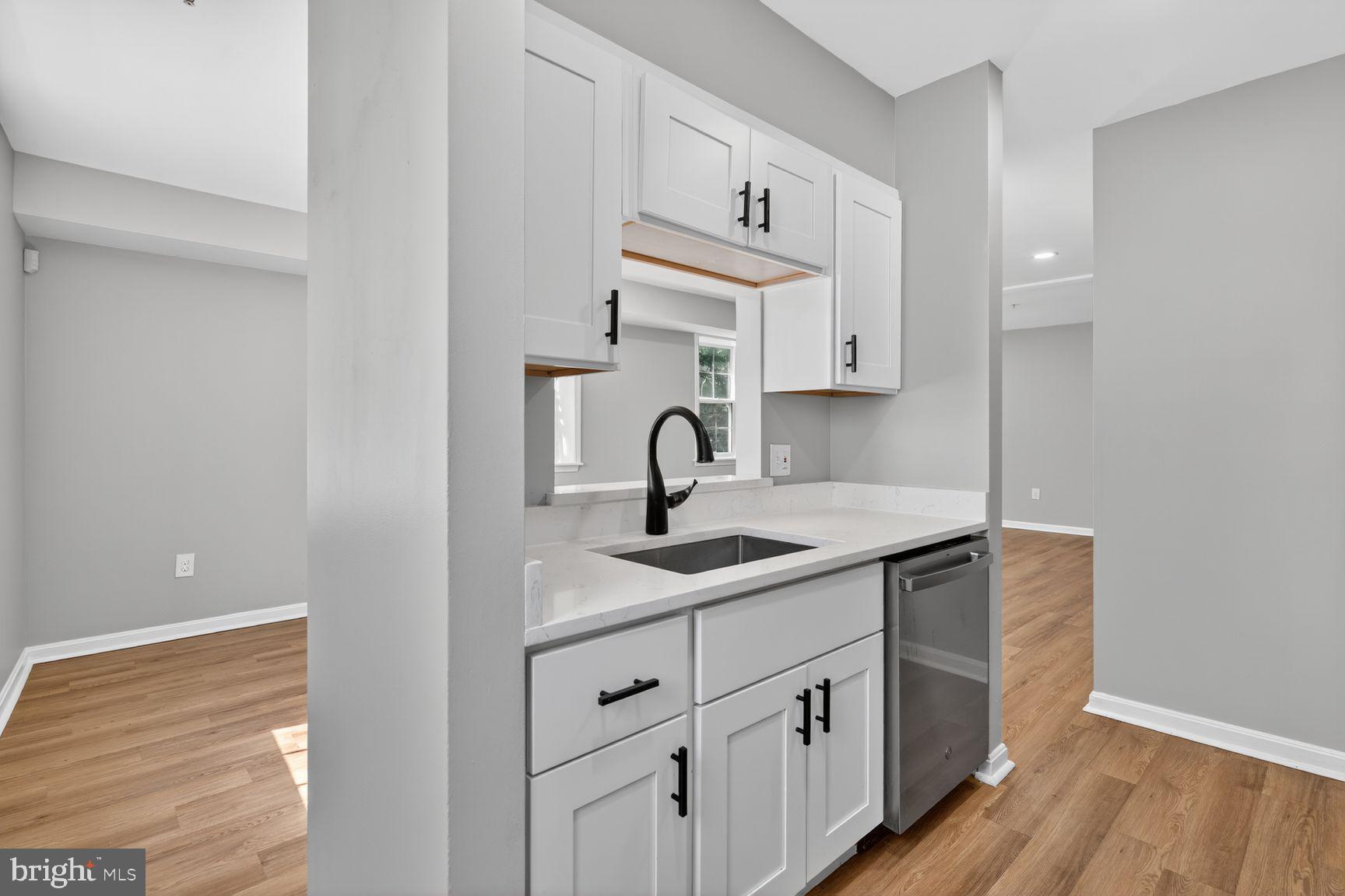 1008 Rittenhouse Street Northwest, Unit 15 Washington, DC 20011 - Photo 10 of 39 a kitchen with cabinets and window