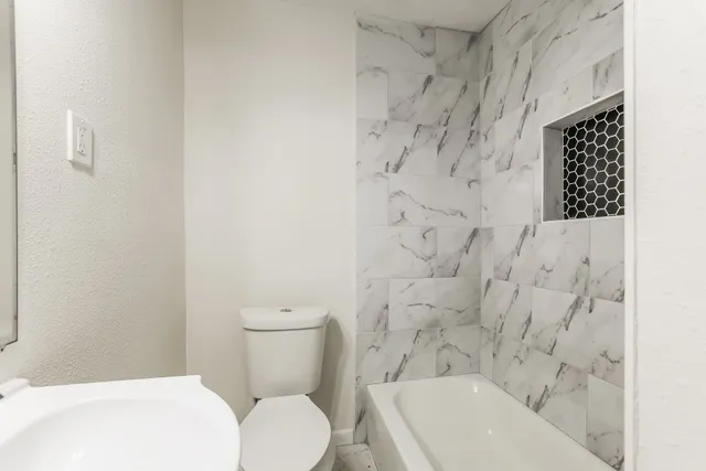 a bathroom with a toilet and a shower curtain