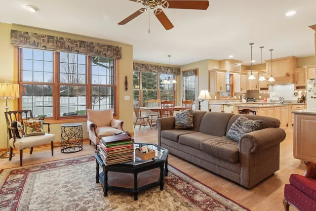 a kitchen with stainless steel appliances granite countertop a stove and white cabinets with wooden floors