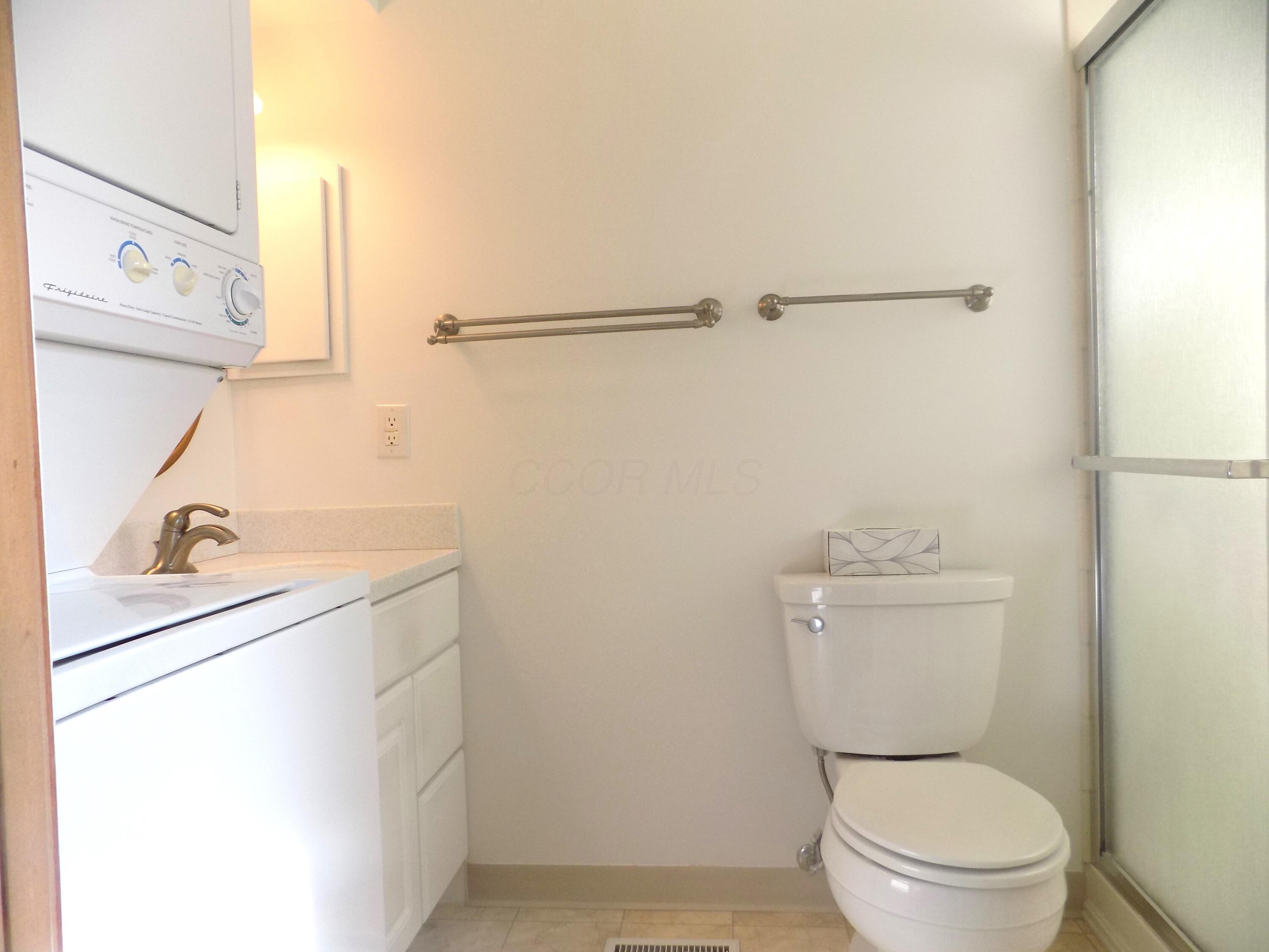 1743 Ardleigh Road Columbus, OH 43221 - Photo 11 of 29 The updated bath has a tiled shower, newer vanity and solid surface countertop & countertop and a stackable washer and dryer for convenience.