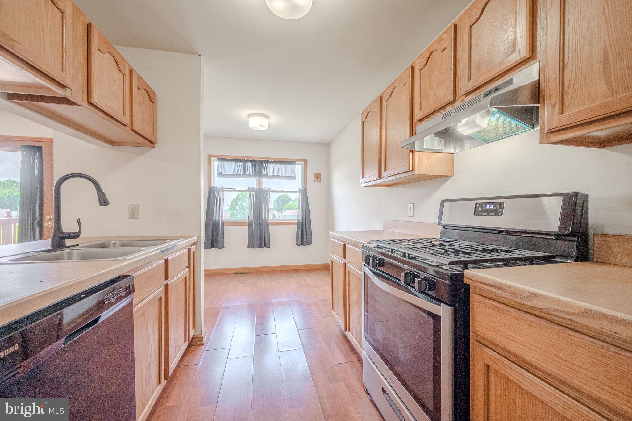 6 Windsor Court Elkton, MD 21921 - Photo 13 of 37 a kitchen with granite countertop a stove and a sink