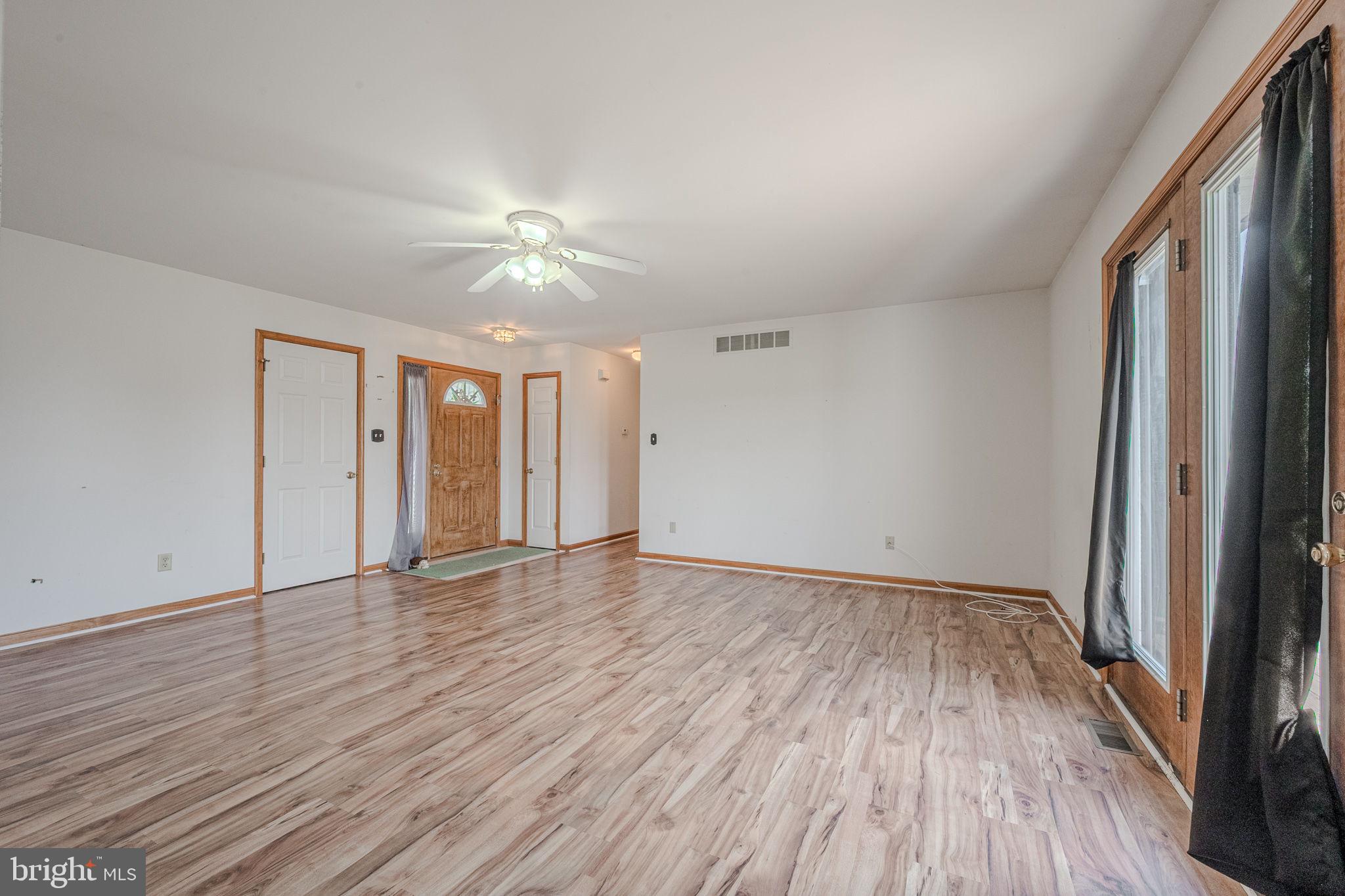 6 Windsor Court Elkton, MD 21921 - Photo 5 of 37 a view of an empty room with wooden floor and a window
