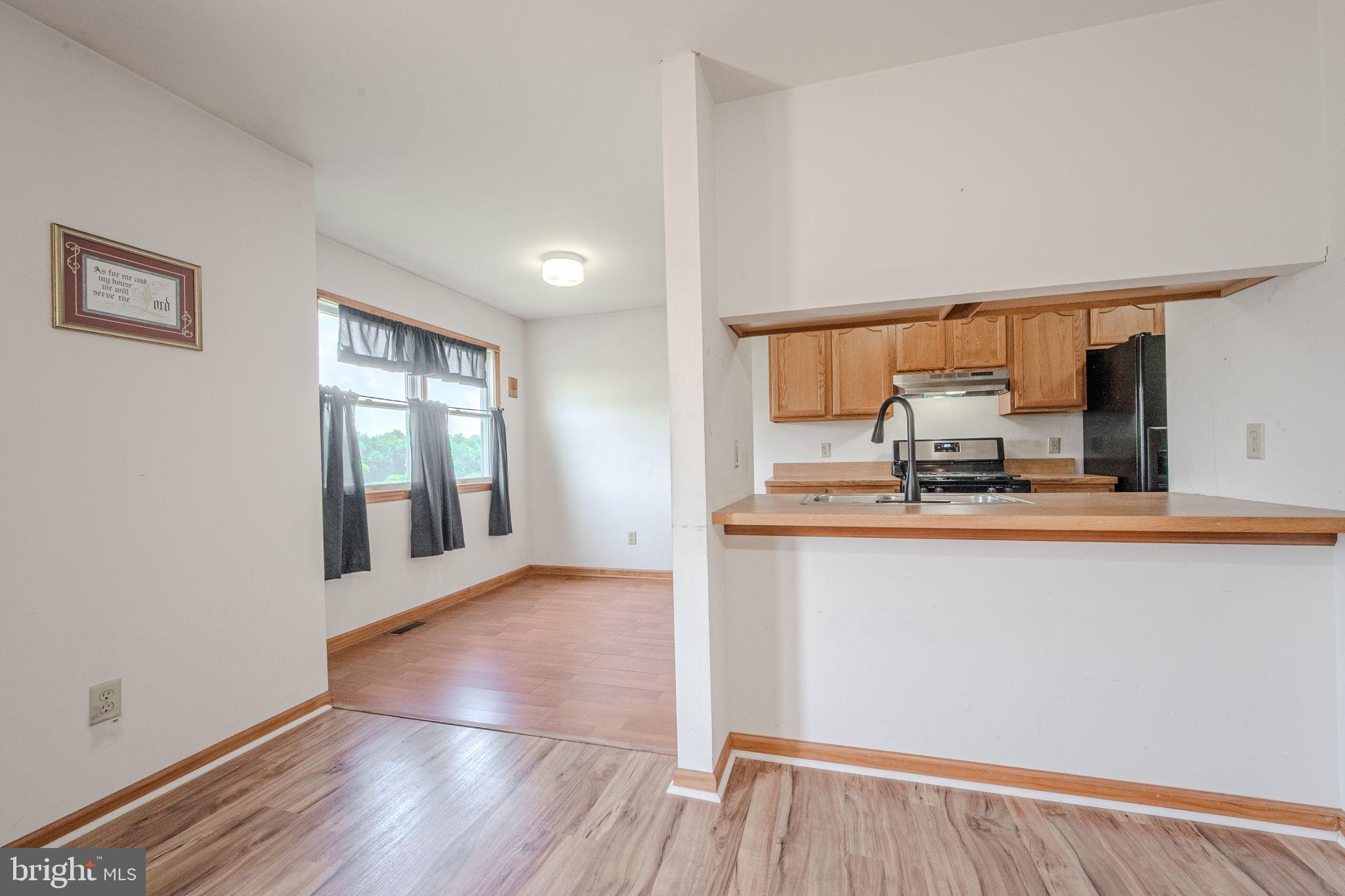 6 Windsor Court Elkton, MD 21921 - Photo 6 of 37 a view of a kitchen with wooden floor and a window