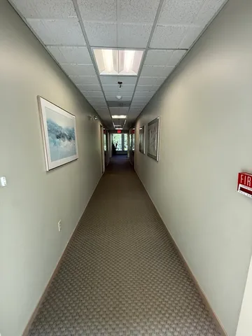 a view of empty room with wooden floor and windows