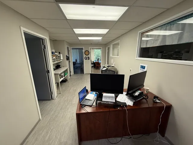 a view of a livingroom with workspace and a window