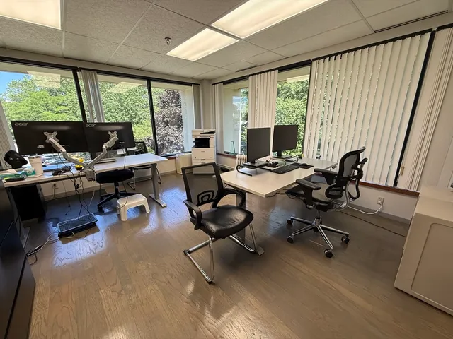 a living room with furniture floor to ceiling window and floor to ceiling window