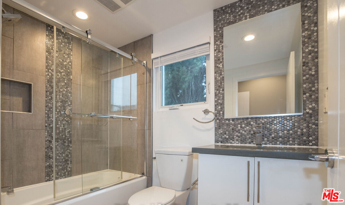 6546 La Mirada Avenue, Unit 6548 Los Angeles, CA 90038 - Photo 17 of 24 a bathroom with a shower and a sink