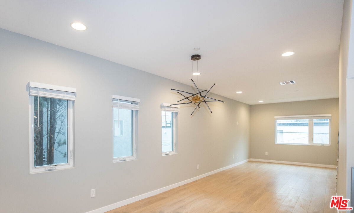 6546 La Mirada Avenue, Unit 6548 Los Angeles, CA 90038 - Photo 9 of 24 wooden floor in an empty room with a window