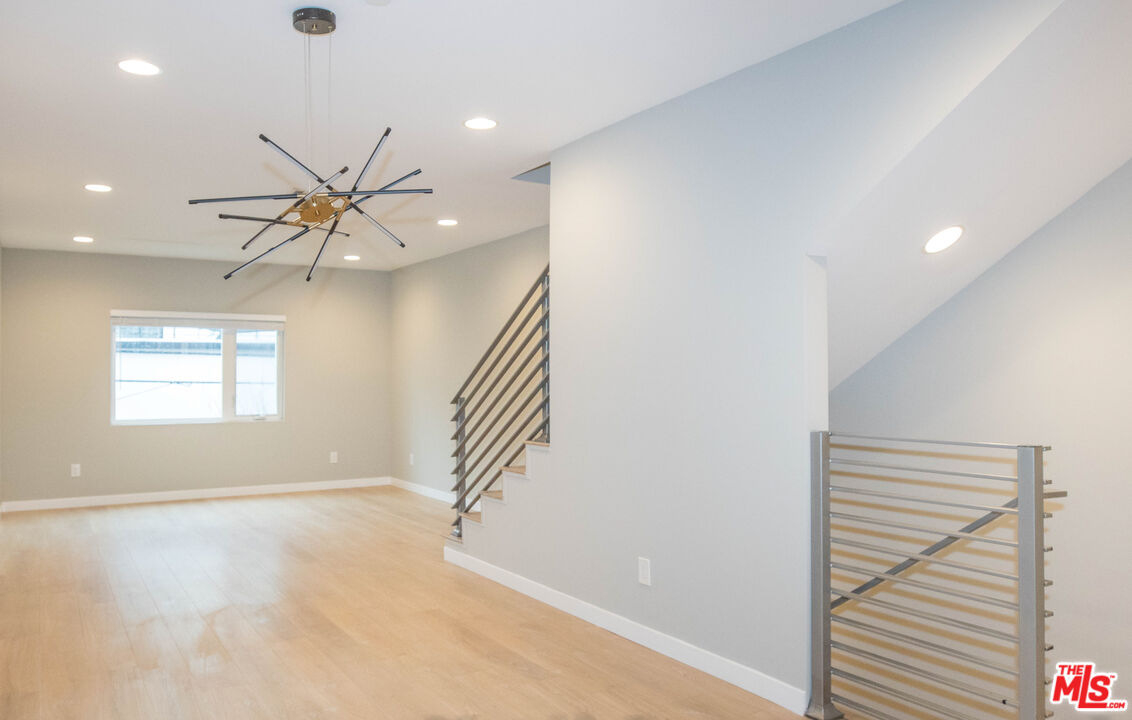 6546 La Mirada Avenue, Unit 6548 Los Angeles, CA 90038 - Photo 10 of 24 an empty room with windows and ceiling fan