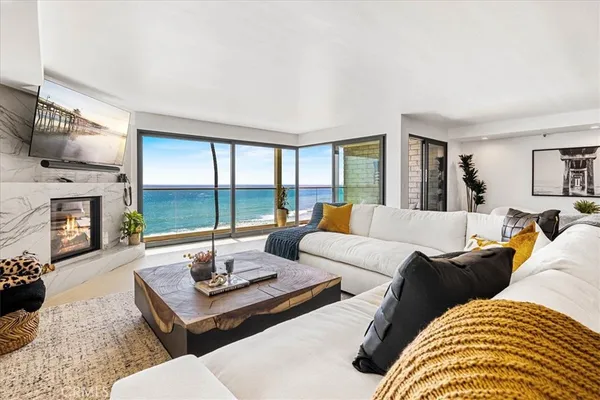 a living room with furniture fireplace and flat screen tv