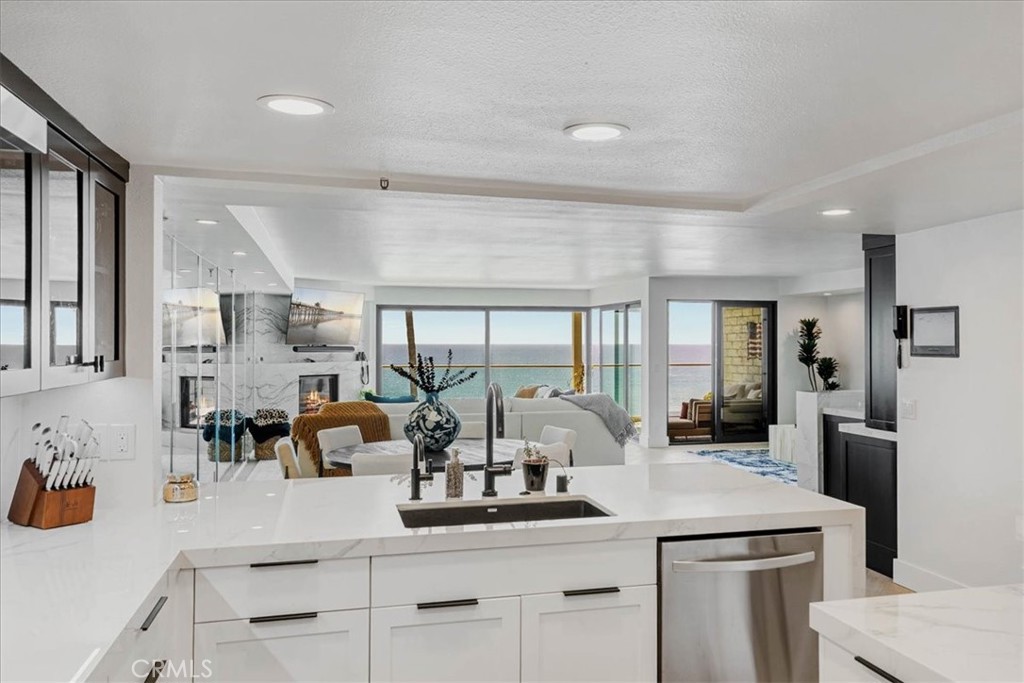 410 Corto Lane, Unit 9 San Clemente, CA 92672 - Photo 15 of 50 a dining hall with stainless steel appliances kitchen island granite countertop a sink and cabinets