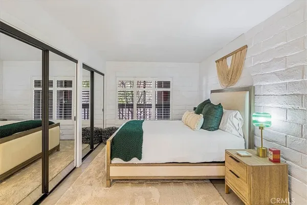 a bedroom with a bed and a large mirror