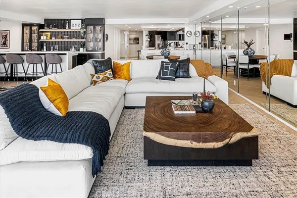 a living room with furniture and a book shelf