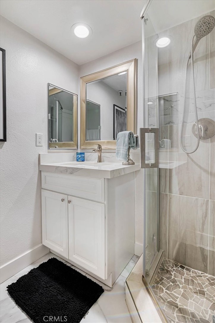 410 Corto Lane, Unit 9 San Clemente, CA 92672 - Photo 31 of 50 a bathroom with a sink and a mirror
