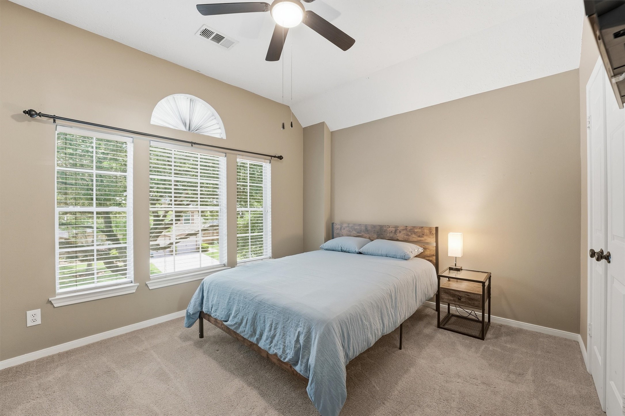 8827 Mile Run Road Humble, TX 77346 - Photo 24 of 37 a bedroom with a bed and a large window