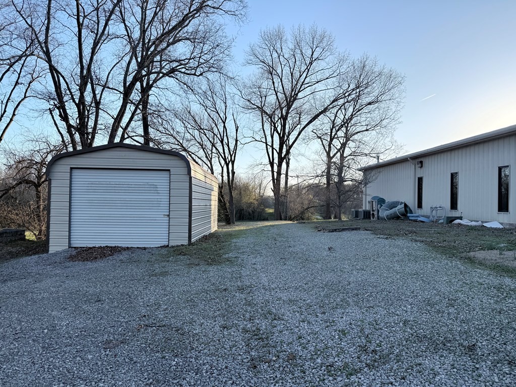 10926 Lafayette Road Herndon, KY 42236 - Photo 11 of 42 a view of a house with a large tree and a forest