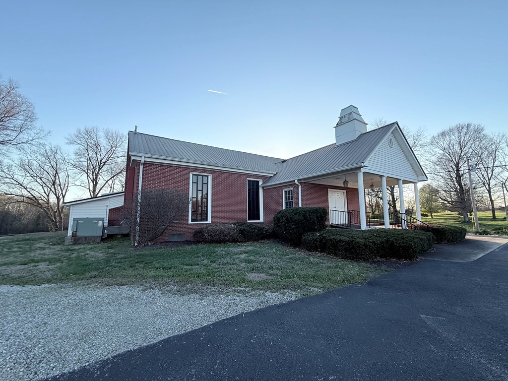 10926 Lafayette Road Herndon, KY 42236 - Photo 14 of 42 a front view of a house with a garden and trees