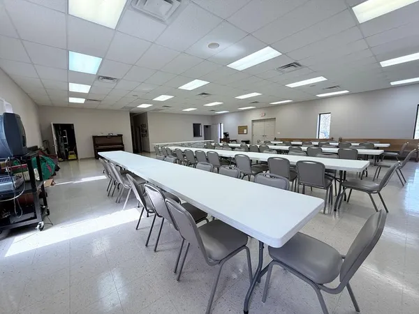 a large kitchen with a table and chairs