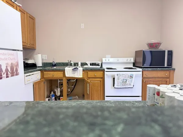 a kitchen with a stove top oven and cabinets