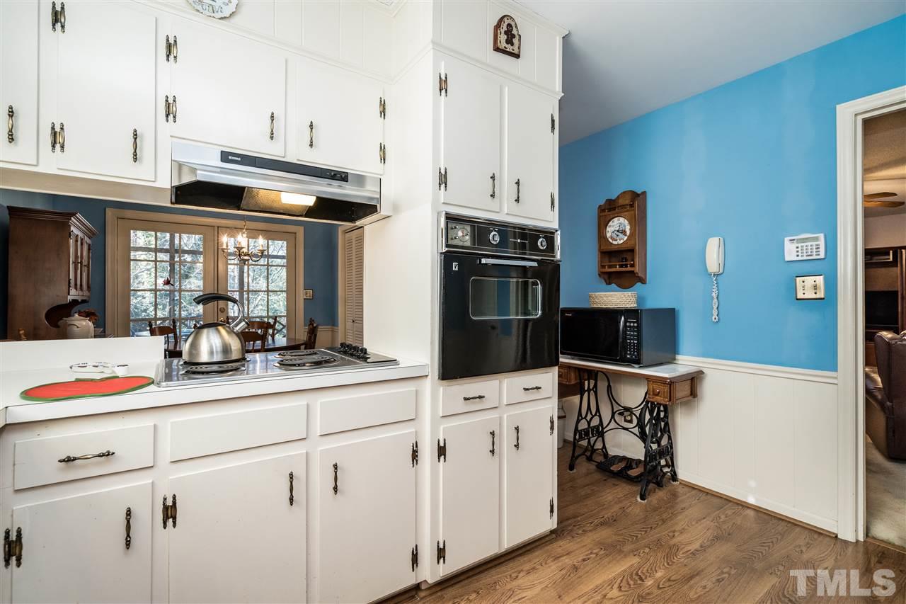 7301 Fiesta Way Raleigh, NC 27615 - Photo 12 of 25 a kitchen with stainless steel appliances kitchen island granite countertop a sink a stove and cabinets