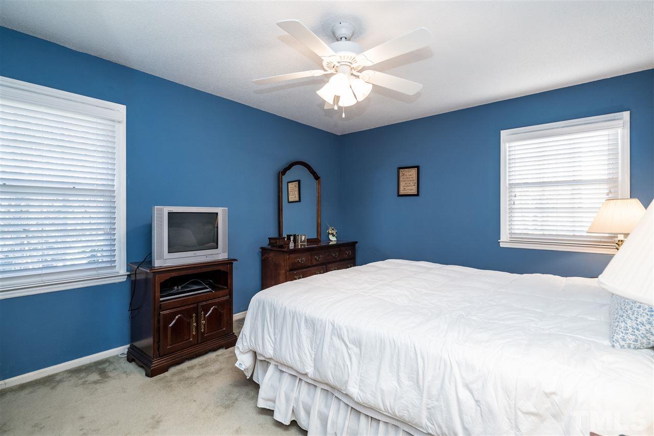 7301 Fiesta Way Raleigh, NC 27615 - Photo 14 of 25 a bedroom with a large bed and a tv