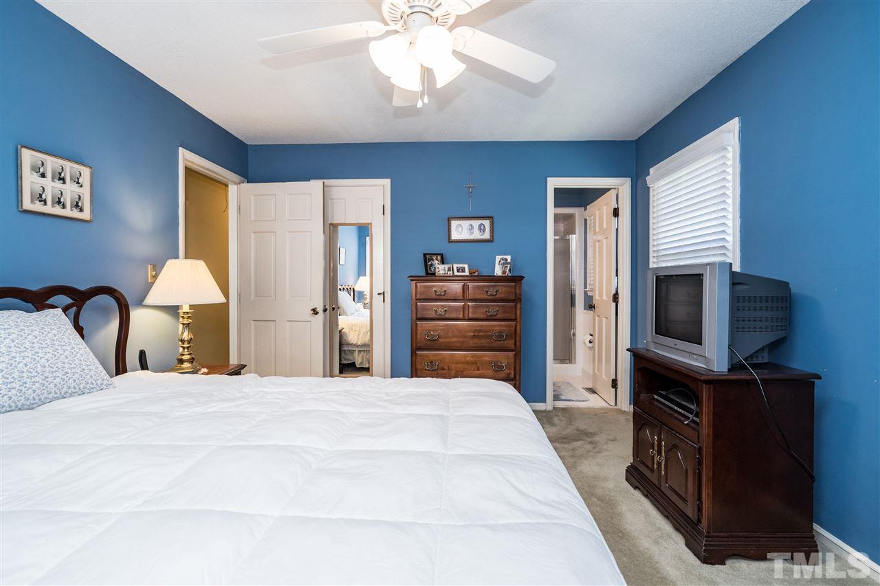 7301 Fiesta Way Raleigh, NC 27615 - Photo 16 of 25 a bedroom with a bed and a flat screen tv
