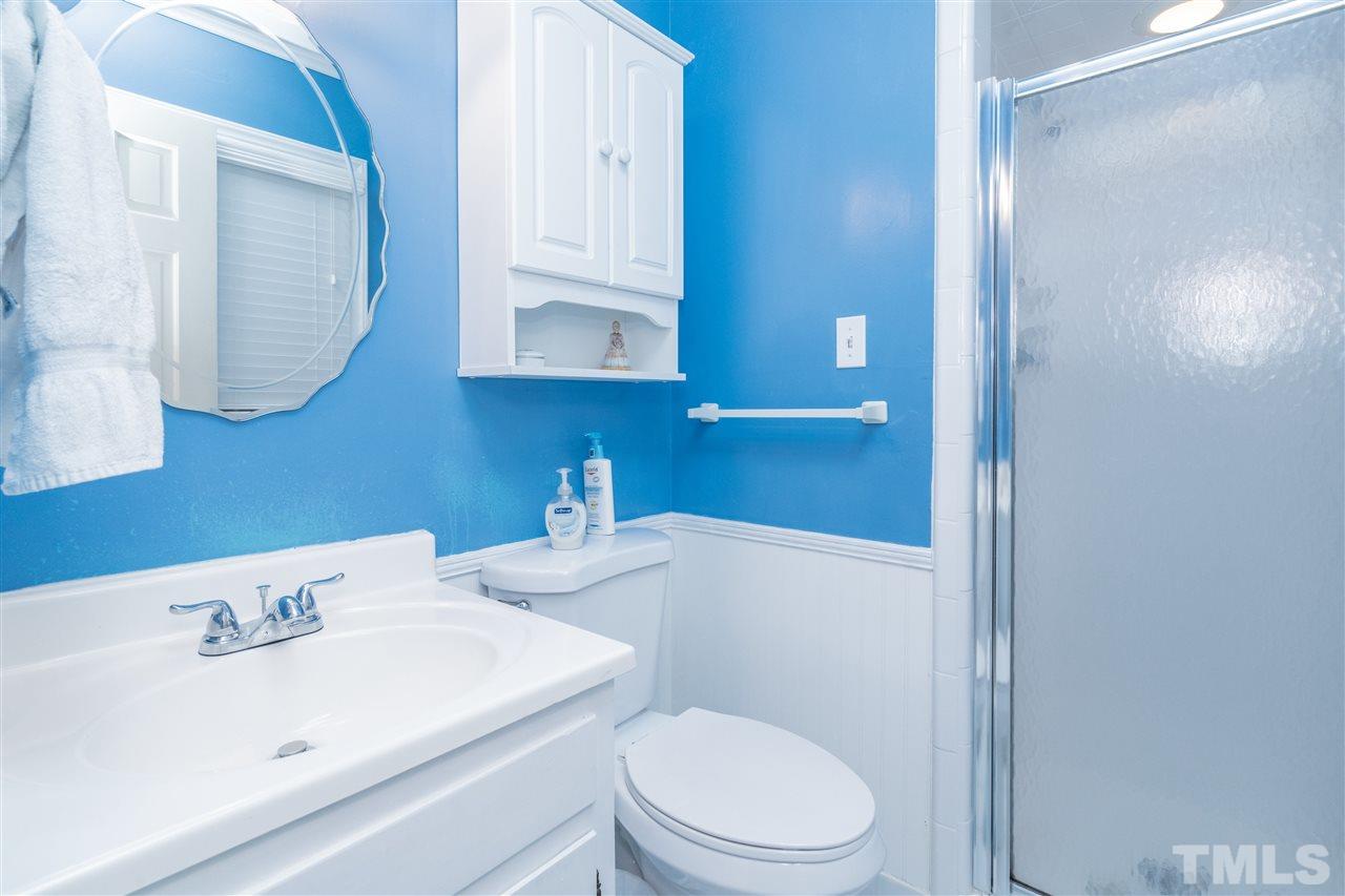 7301 Fiesta Way Raleigh, NC 27615 - Photo 17 of 25 a bathroom with a sink a toilet and mirror