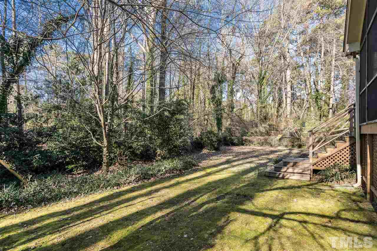 7301 Fiesta Way Raleigh, NC 27615 - Photo 23 of 25 a view of a yard with plants and trees