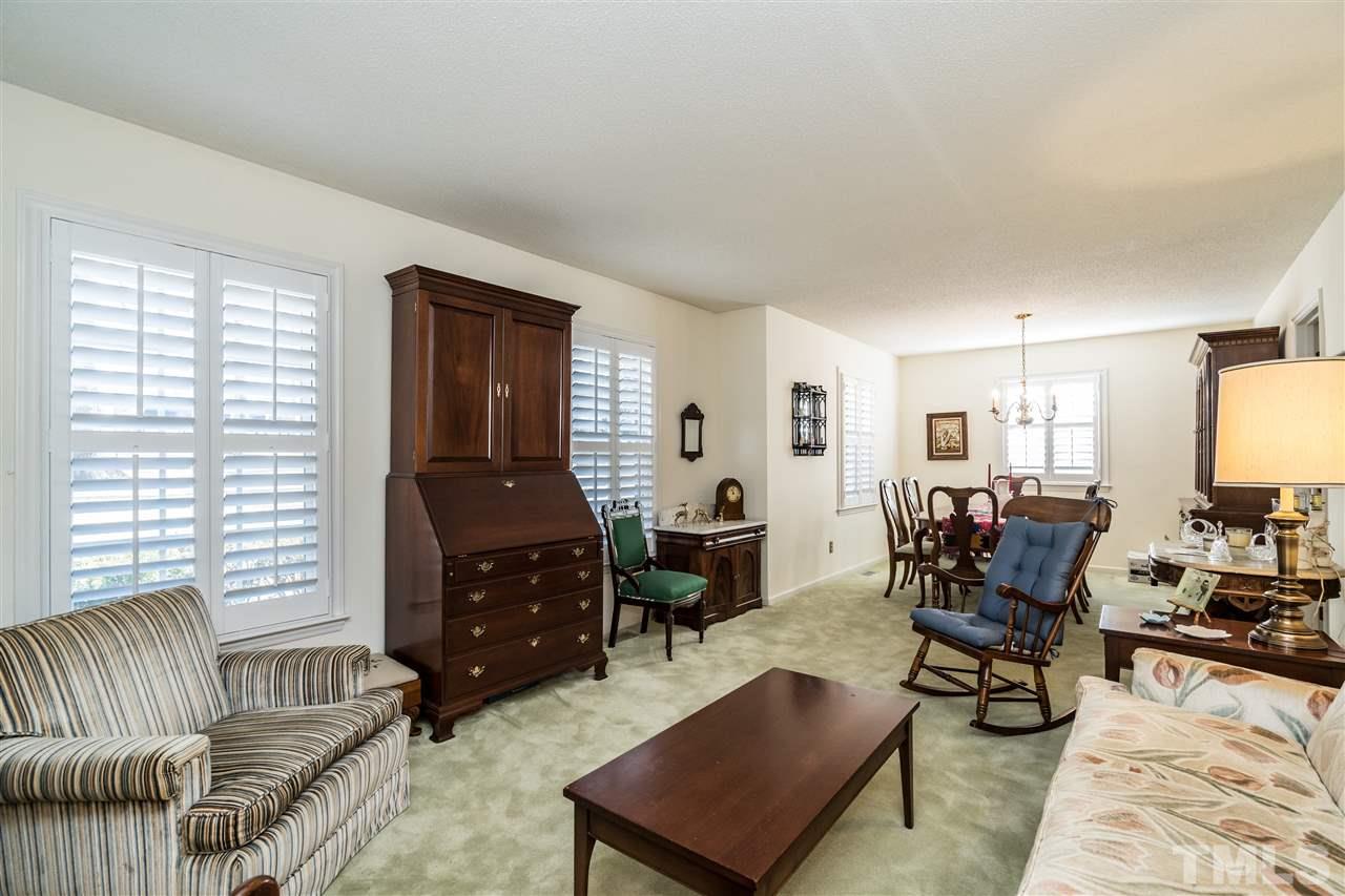 7301 Fiesta Way Raleigh, NC 27615 - Photo 5 of 25 a living room with furniture and wooden floor