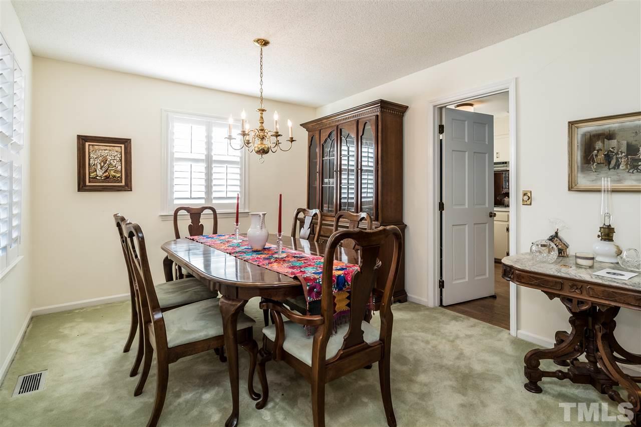 7301 Fiesta Way Raleigh, NC 27615 - Photo 6 of 25 a view of a dining room with furniture and a chandelier