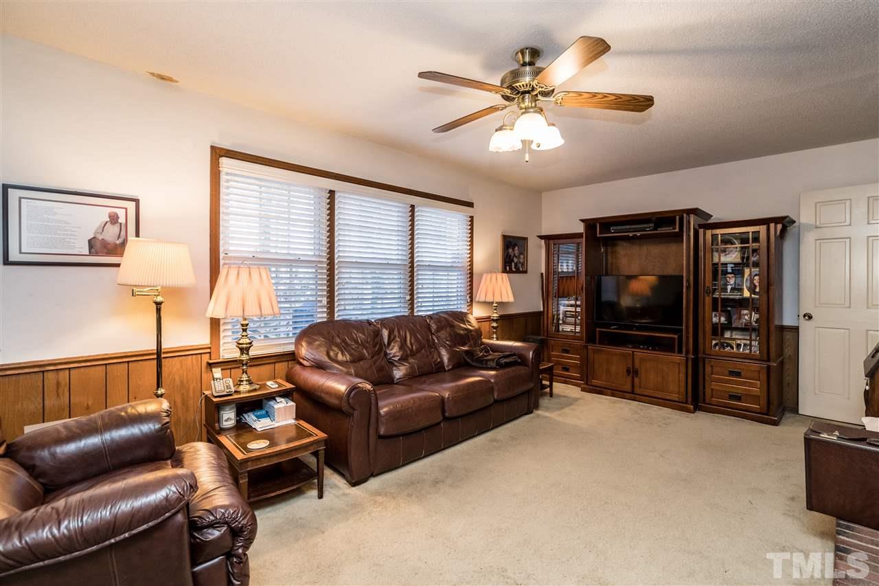 7301 Fiesta Way Raleigh, NC 27615 - Photo 8 of 25 a living room with furniture and a flat screen tv