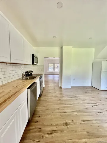 a kitchen with stainless steel appliances granite countertop a stove and a sink