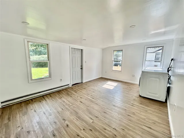 wooden floor in an empty room with a window