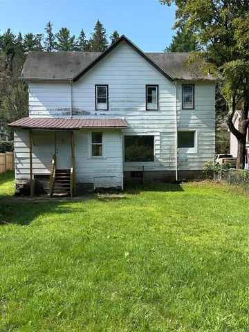 a front view of a house with a garden