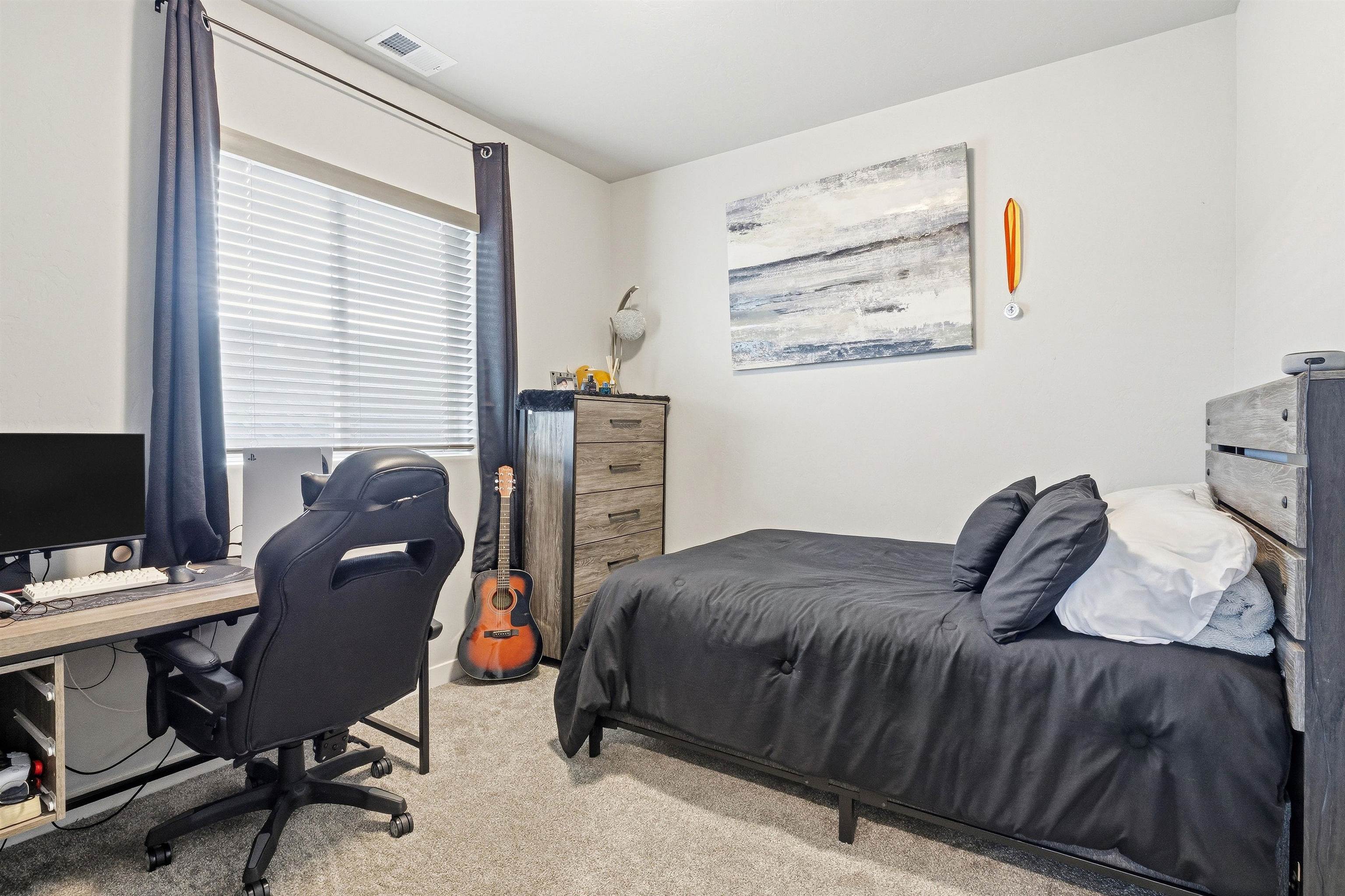 2459 Hamilton Road, Unit A Grand Junction, CO 81505 - Photo 24 of 27 a bedroom with a bed and a desk