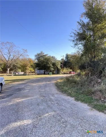 a view of an outdoor space with trees all around