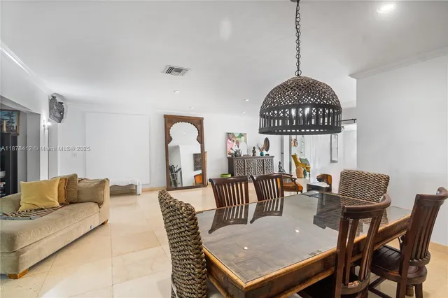 a living room with furniture a table and a chandelier