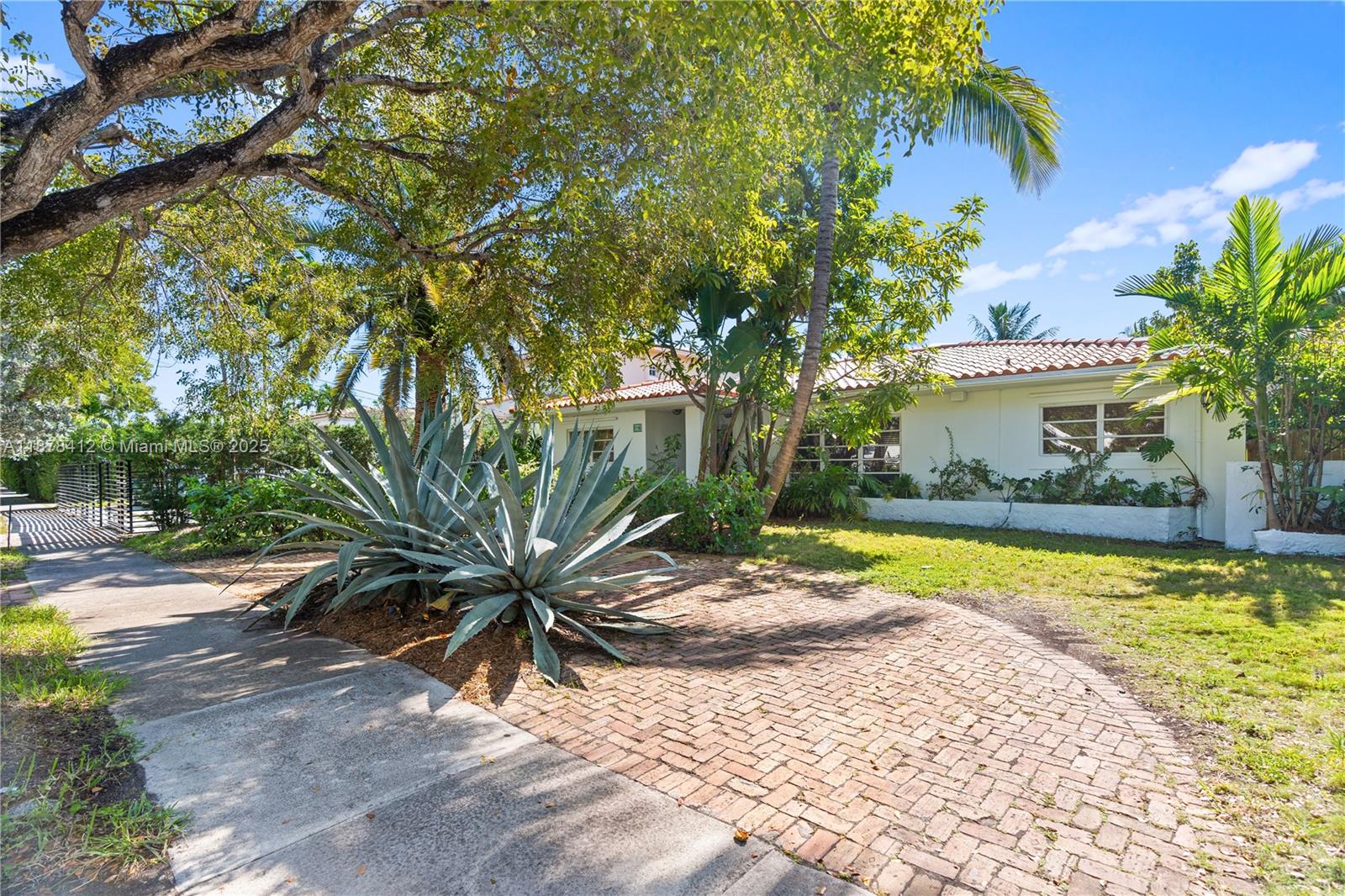 1710 Cleveland Road Miami Beach, FL 33141 - Photo 17 of 36 a view of a swimming pool with plants and palm trees