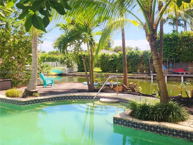 a view of a house with a yard patio and swimming pool