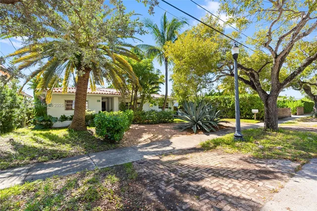 a view of a house with a tree in the yard