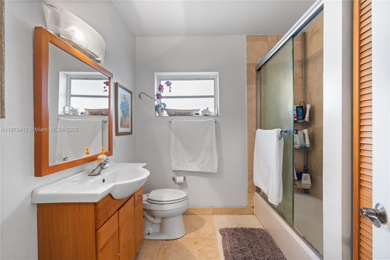 1710 Cleveland Road Miami Beach, FL 33141 - Photo 27 of 36 a bathroom with a toilet a sink and a mirror