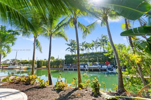 a view of a swimming pool with a patio and a yard