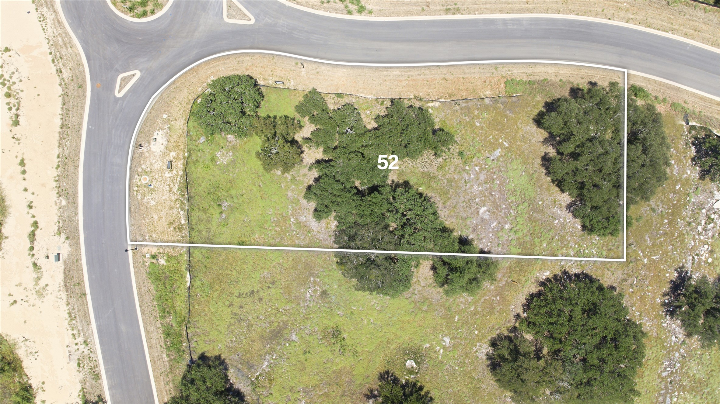 201 Lightning Rnch Road Georgetown, TX 78628 - Photo 4 of 7 A generous lot with mature trees, bordered by a curving road, ready for development.